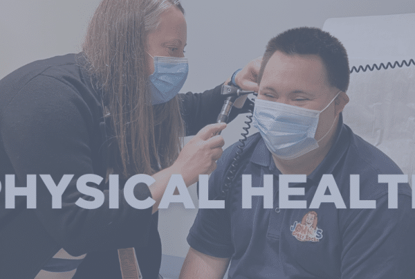 Doctor looks into a patient's ears during a physical exam.