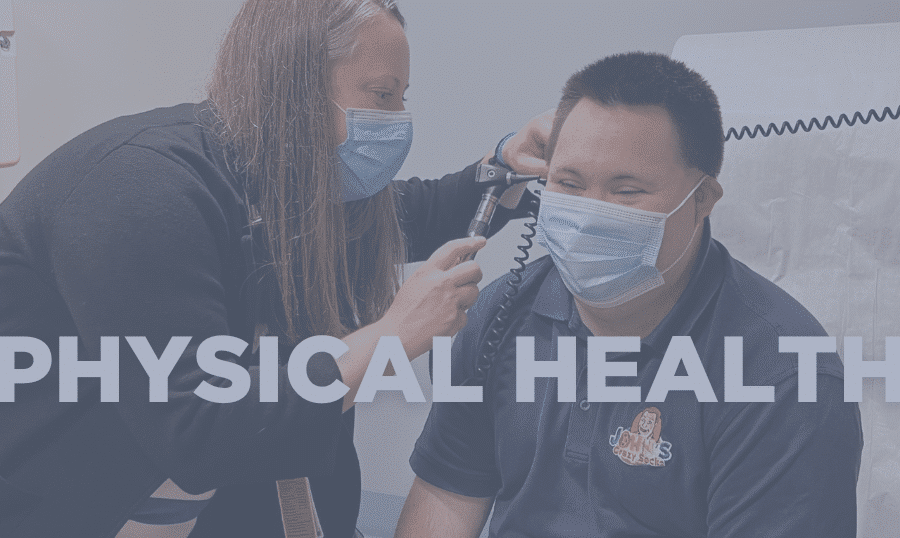 Doctor looks into a patient's ears during a physical exam.