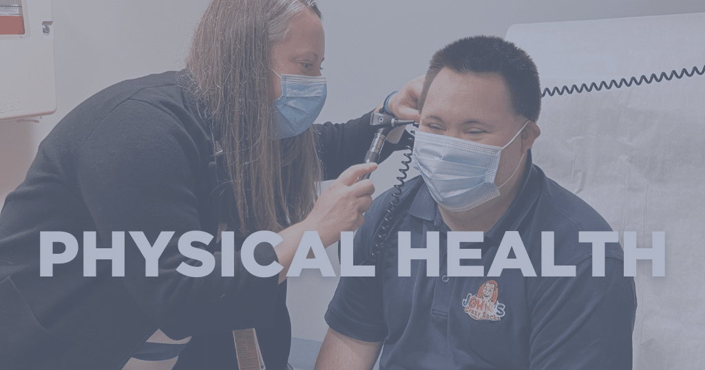 Doctor looks into a patient's ears during a physical exam.